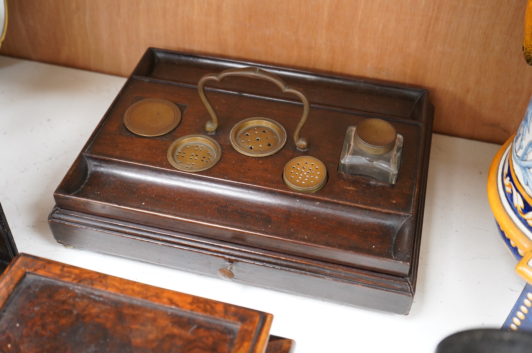 A collection of sundry items to include a Coromandel and brass mounted ink blotter pad, an early 19th century French yew veneered travelling writing box, an early 19th century mahogany desk stand and burr walnut bombé sh